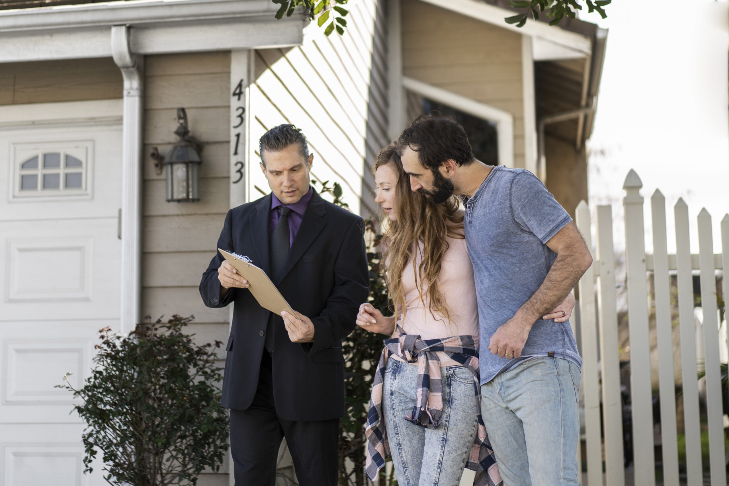 couple signing papers for new home and property insurance