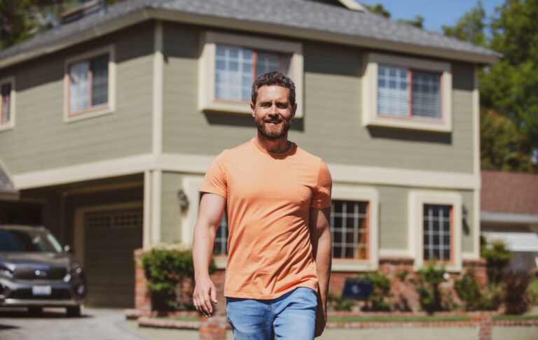 man standing outside new home successful real estate purchasing house insurance